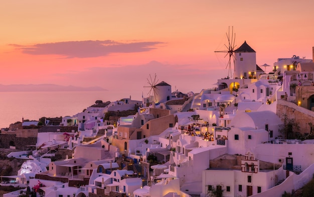 Oia village Santorini Greece View of traditional houses in Santorini Small narrow streets and rooftops of houses churches and hotels Landscape during sunset Travel and vacation photography