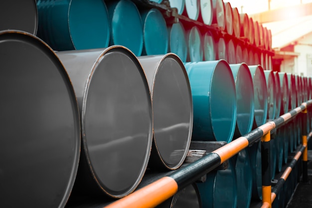 Oil barrels blue and green or chemical drums horizontal stacked up