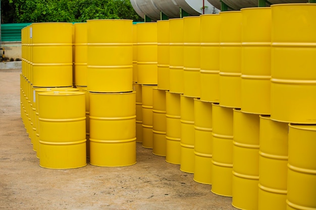 Oil barrels yellow or chemical drums vertical stacked up.