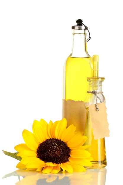 Oil in bottle and sunflower, on white