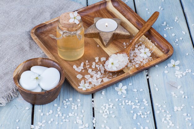 oil, candle, salt in a spoon, stones - items for spa