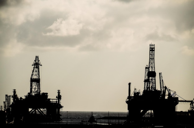 Oil Drilling Rig Silhouette over a Cloudy Sky