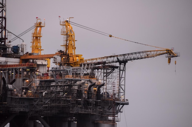 Oil Drilling Rig Silhouette over a Cloudy Sky