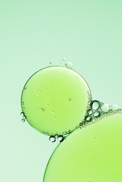 Oil droplets on water surface background Abstract green background