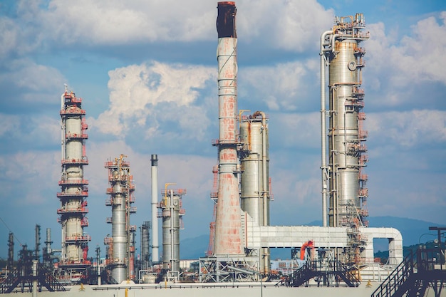 Oil and gas industry tank refinery tower crude oil pipeline the tank in the cloud sky