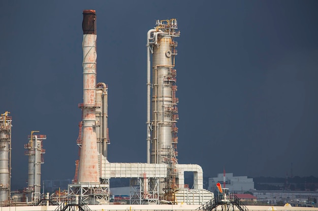 Oil and gas industry tank refinery tower crude oil pipeline the tank in the cloud storm.