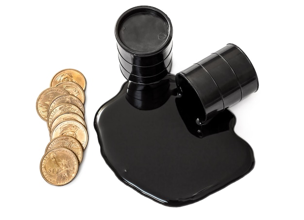 Oil is poured out of the barrel and full barrel of oil with golden coins Isolated on white Top view