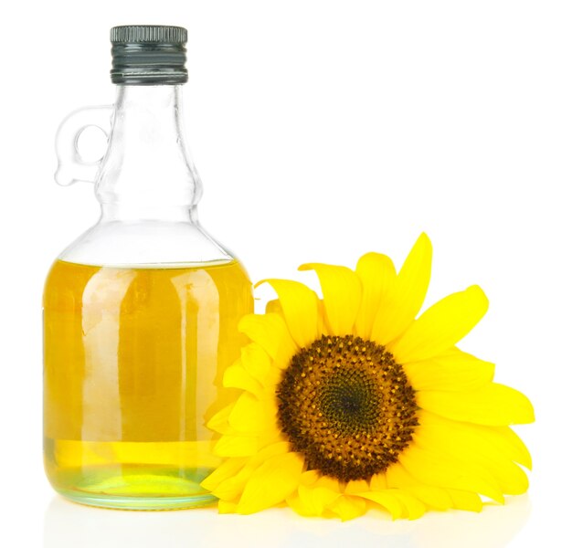 Oil in jar and sunflower isolated on white