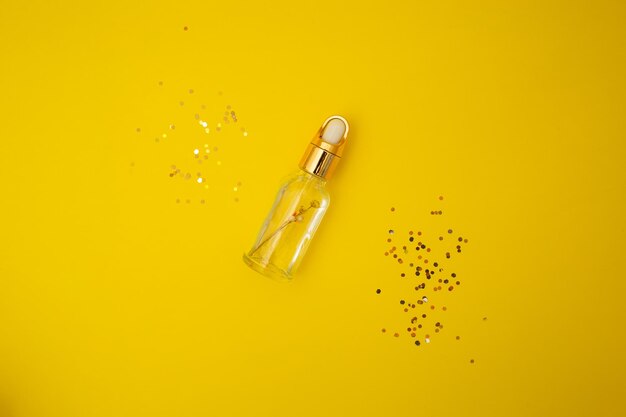 Oil in a jar on a yellow background