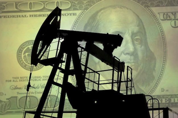 Oil pump on background of US dollar