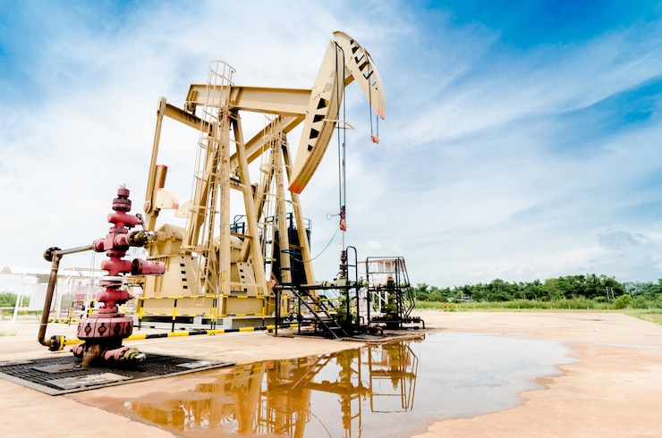 Oil pump moving. Oil industry equipment with blue sky