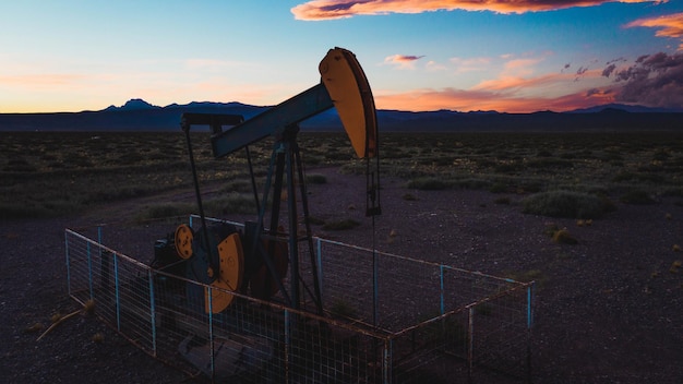 Oil pump for petroleum in the sunset background