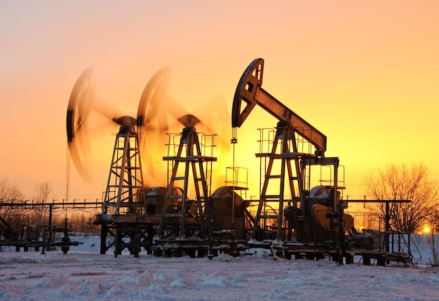 oil pumps at sunset sky background