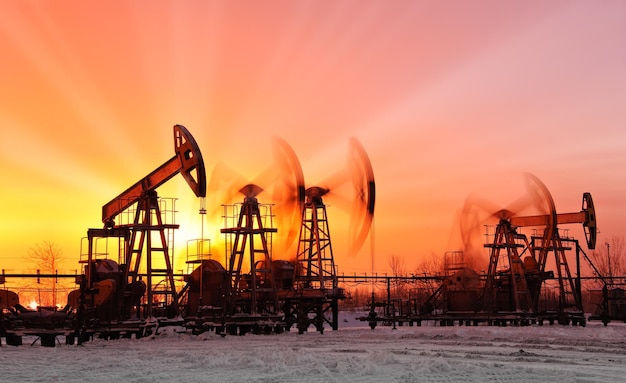 oil pumps at sunset sky background