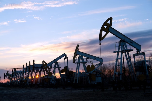 oil pumps at sunset sky  background