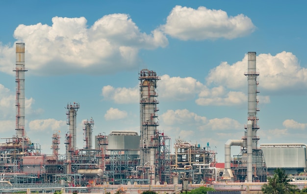 Oil refinery or petroleum refinery plant with blue sky background. Power and energy industry. Oil and gas production plant. Petrochemical industry. Natural gas storage tank. Petroleum business.