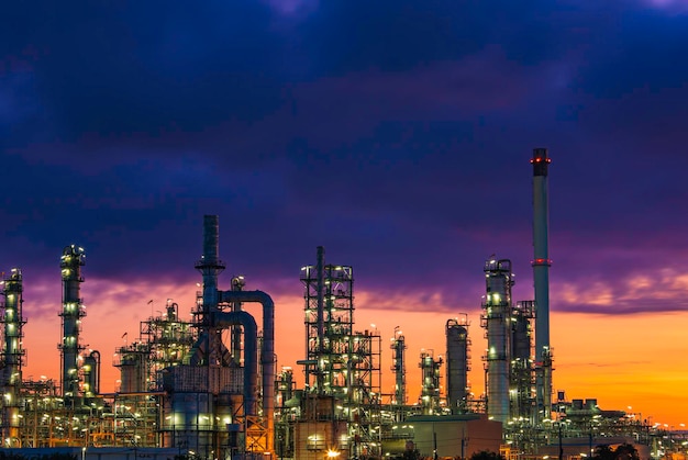 Photo oil refinery and plant and tower of petrochemistry industry in oil and gas industry with cloud blue sky the morning