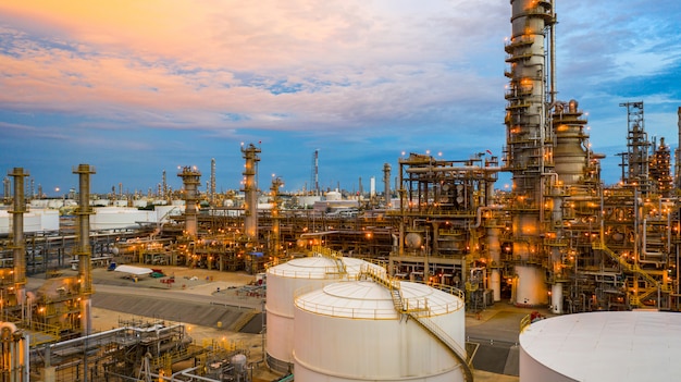 Oil refinery at twilight, Aerial view petrochemical plant and oil refinery plant background at night,  Petrochemical oil refinery factory plant at twilight.