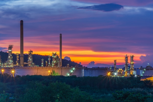 Oil refinery at twilight with sky background.