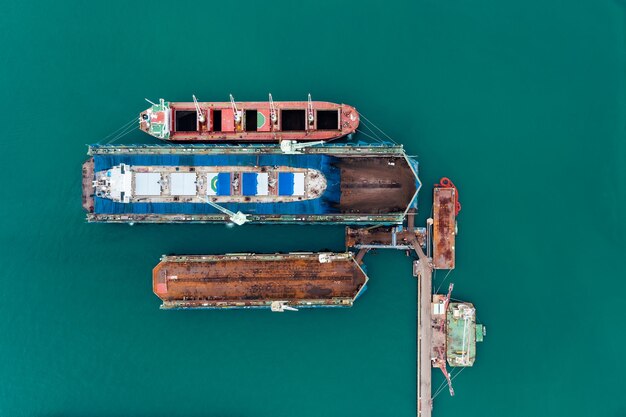 Photo oil tank ship repairing and maintenance on shipyard dock in sea aerial top view from drone