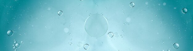 Photo oil and water transparent blue bubbles soap suds with water blue background space for copy