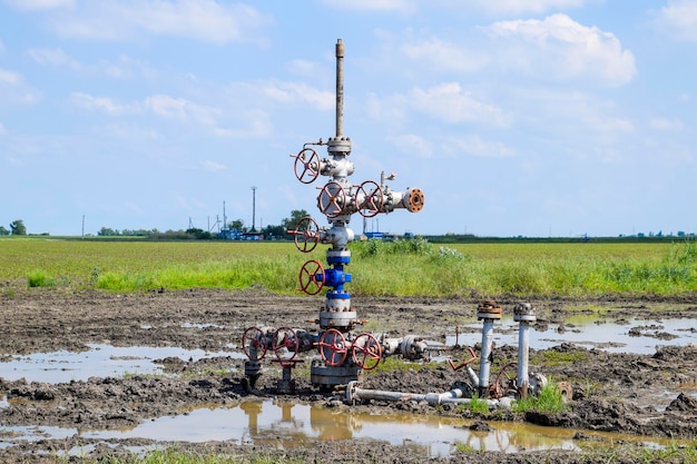 Photo oil well after repair in mud and puddles