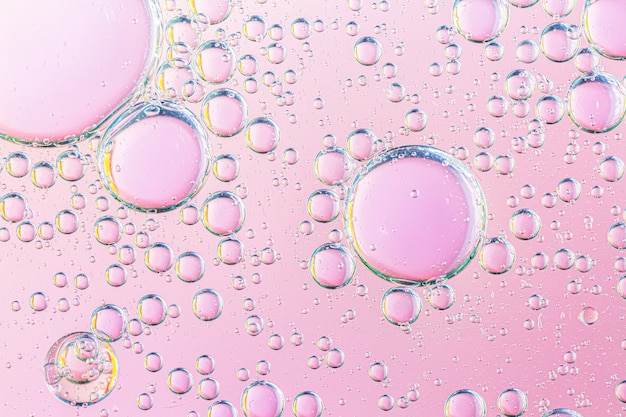 oil with bubbles on coral background Pink Abstract space background Soft selective focus