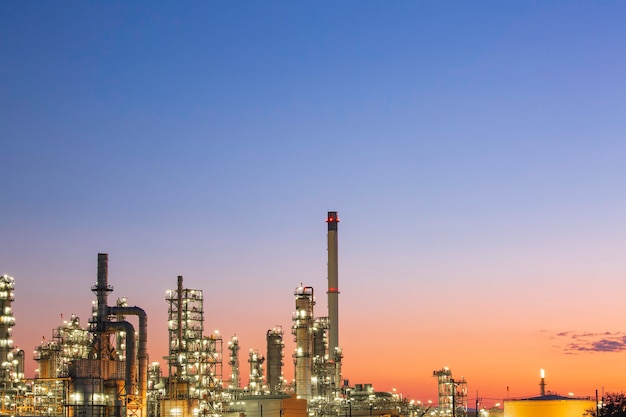 Oilâ refineryâ andâ plant and tower column of petrochemistry industry in oilâ andâ gasâ âindustrial withâ cloudâ blueâ âsky the sunriseâ backgroundâ