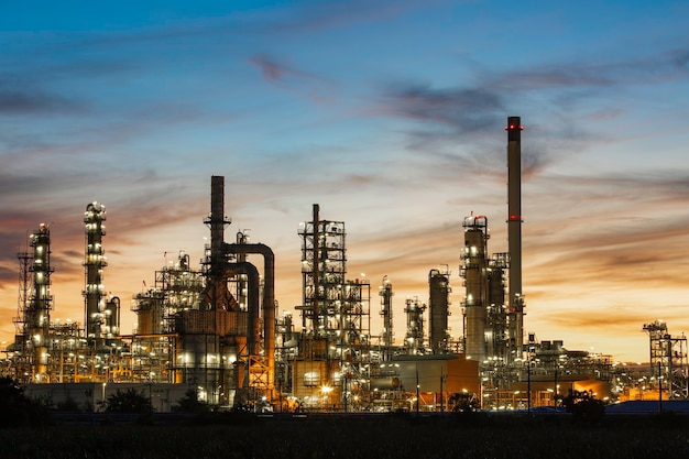 Oilâ refineryâ andâ plant and tower column of petrochemistry industry in oilâ andâ gasâ âindustrial withâ cloudâ orangeâ âsky the sunriseâ backgroundâ