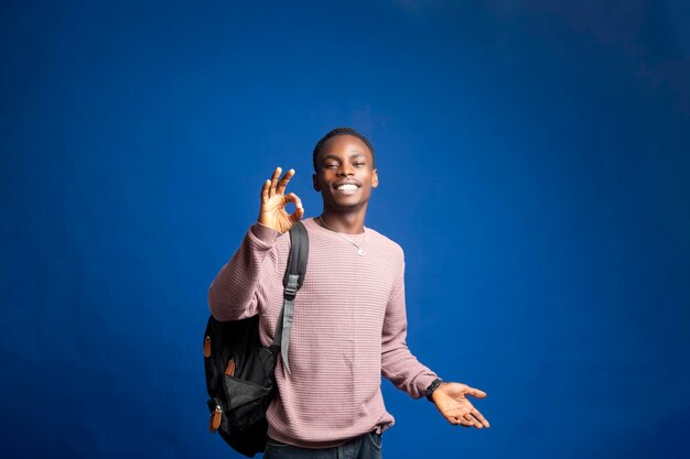 Okay Excited Black Man Gesturing OK Smiling At Camera Standing On Yellow Studio Background