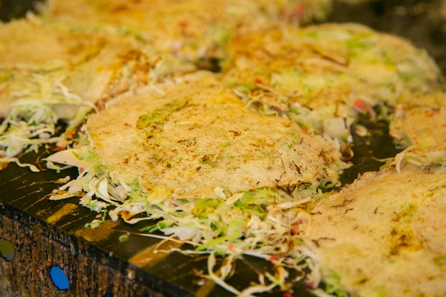 Okonomiyaki is a savory Japanese cabbage pancake grilled as you like it with your choice of protei