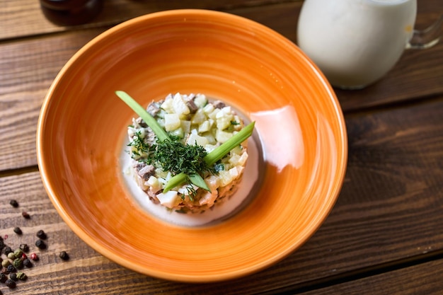 Okroshka with dressing on a wooden table