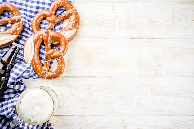 Oktoberfest food menu, bavarian sausages with pretzels, mashed potato, sauerkraut, beer bottle and mug