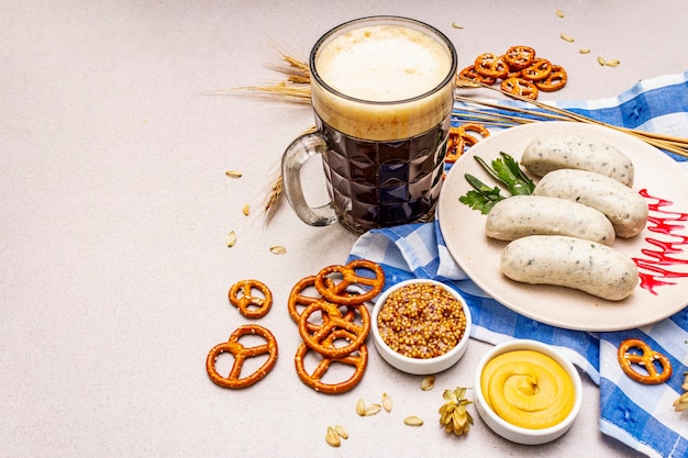 Oktoberfest set. Dark beer, weisswurst, pretzels, mustard, spikelets of grain, hop