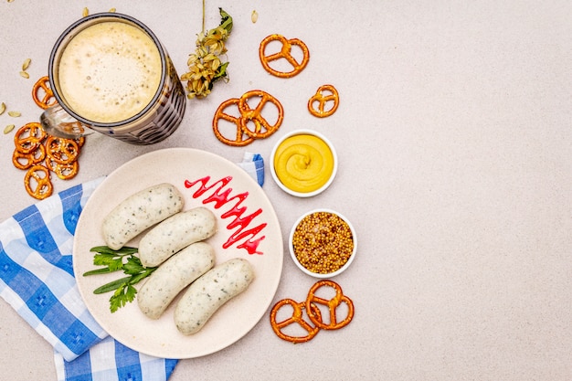 Oktoberfest set. Dark beer, weisswurst, pretzels, mustard, spikelets of grain, hop