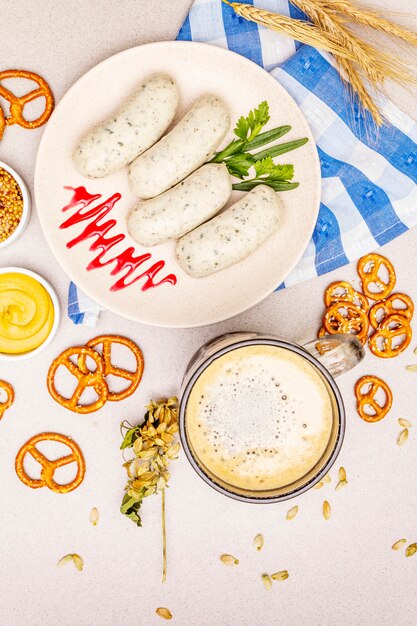 Oktoberfest set. Dark beer, weisswurst, pretzels, mustard, spikelets of grain, hop