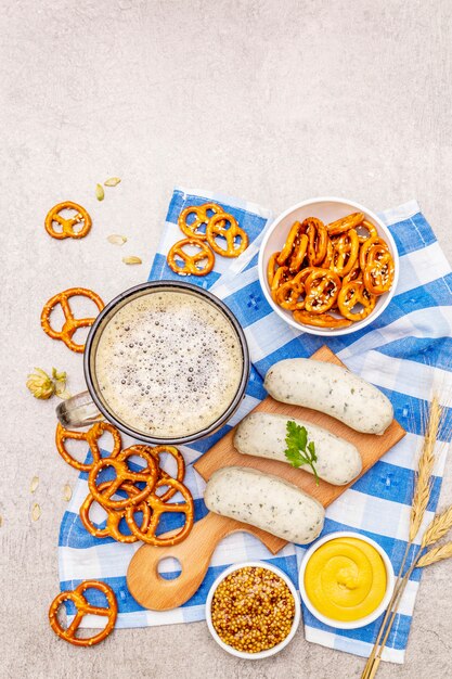 Oktoberfest set. Dark beer, weisswurst, pretzels, mustard, spikelets of grain, hop