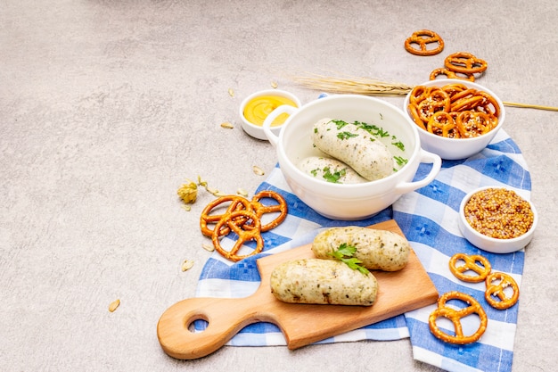 Oktoberfest set. White sausage weisswurst, pretzels, mustard, spikelets of grain, hop