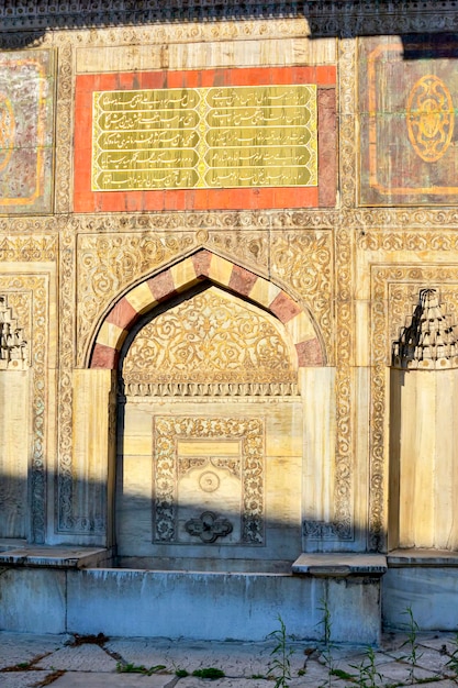 Ol and historic muslim portal with washbasin and arabesques in Istanbul Turkey