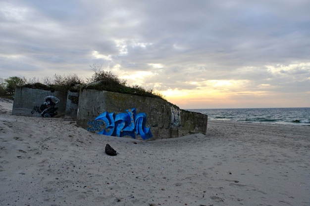 Old abandoned defensive bunker sandy shore Baltic Sea