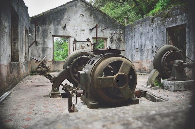 Old and abandoned factory that still has very old machinery old structures that are in the middle of the forest