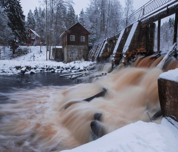 An old abandoned Finnish hydroelectric power station on the Volchya River in the Varyamyanselka Ridge  in winter frost