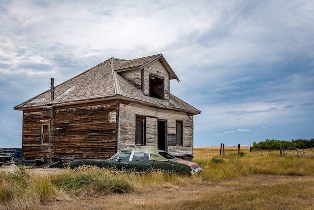 An old abandoned home and classic car in the Canadian ghost town of Robsart Saskatchewan