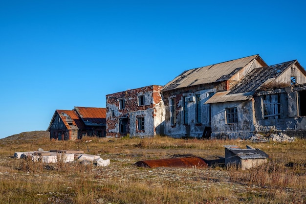 An old abandoned houses in the field closeup photo