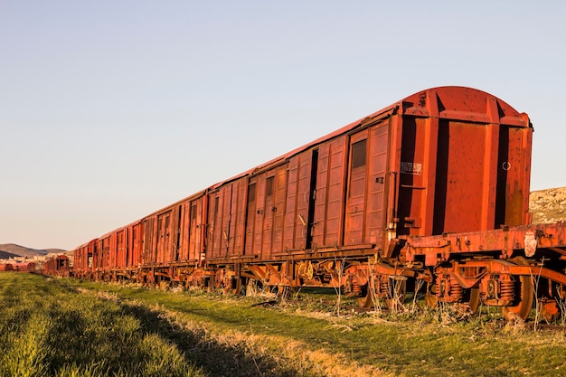 Old abandoned rusty train in the field