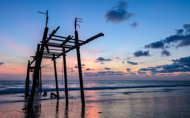 Old abandoned wooden bridge with seascape sunset sky