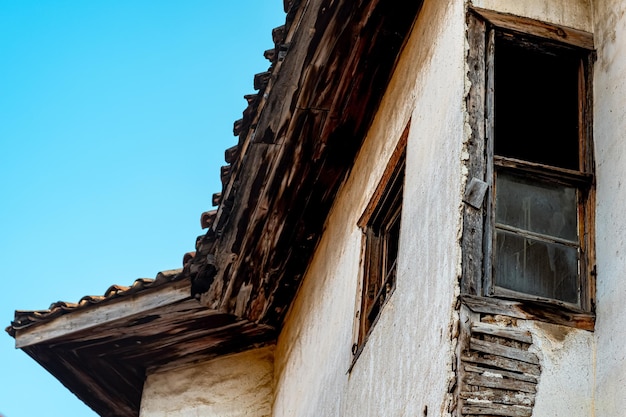 Old abandoned wooden house with broken glass fragment