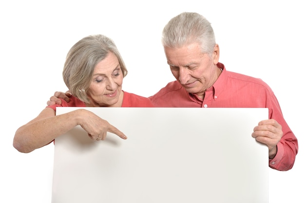 Old age couple holding blank banner ad against white background
