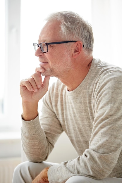 old age, vision and people concept - close up of smiling senior man in glasses