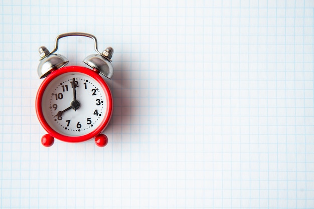 old alarm clock on a clean notebook